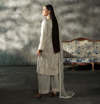 This 3 piece readymade attire features detailed handwork of thread cut…